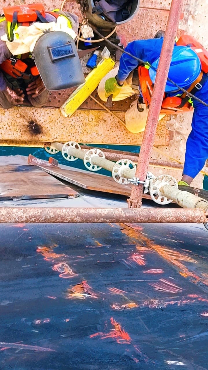 Technical crew carrying out work on marine equipment